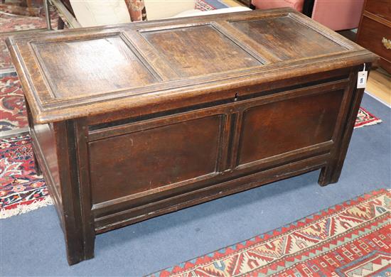 An 18th century panelled oak coffer W.130cm